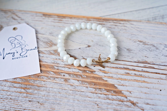 White beaded bracelet with bird charm